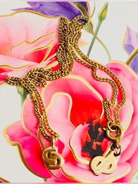Like New Dior intricately designed gold necklace with renowned logo CD pendants